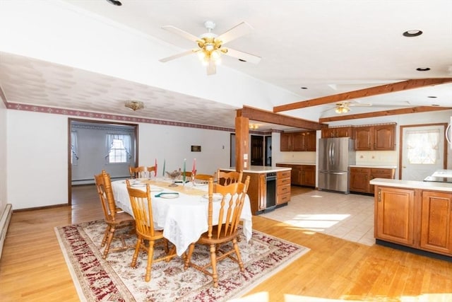 dining area with lofted ceiling, a baseboard heating unit, ceiling fan, and light hardwood / wood-style flooring