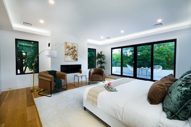 bedroom featuring access to outside and hardwood / wood-style flooring