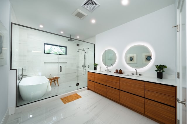 bathroom featuring vanity and separate shower and tub