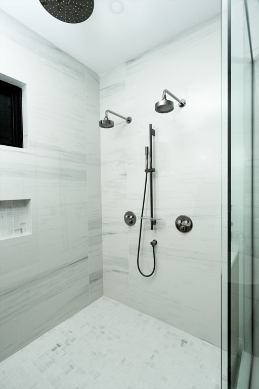 bathroom with tiled shower