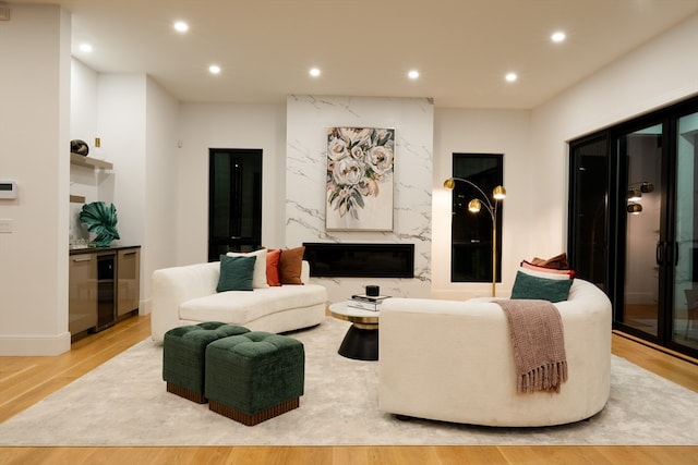 living room featuring beverage cooler and light hardwood / wood-style flooring