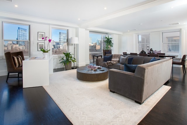 living area featuring visible vents, wood finished floors, and crown molding