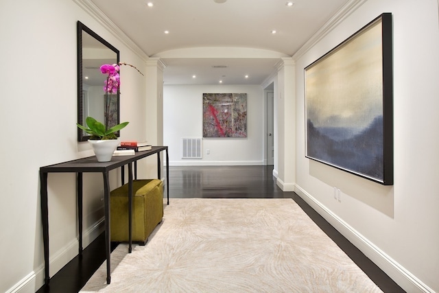 hall featuring crown molding and dark hardwood / wood-style floors