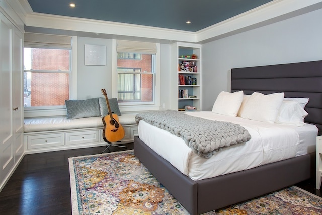 bedroom featuring crown molding, dark wood-type flooring, and multiple windows