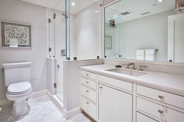 bathroom with vanity, an enclosed shower, and toilet