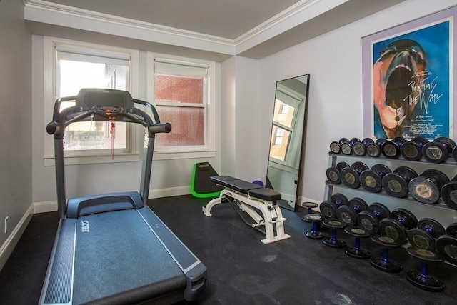 exercise room featuring crown molding and baseboards