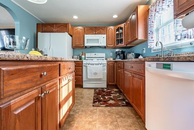 kitchen with white appliances and light tile patterned flooring