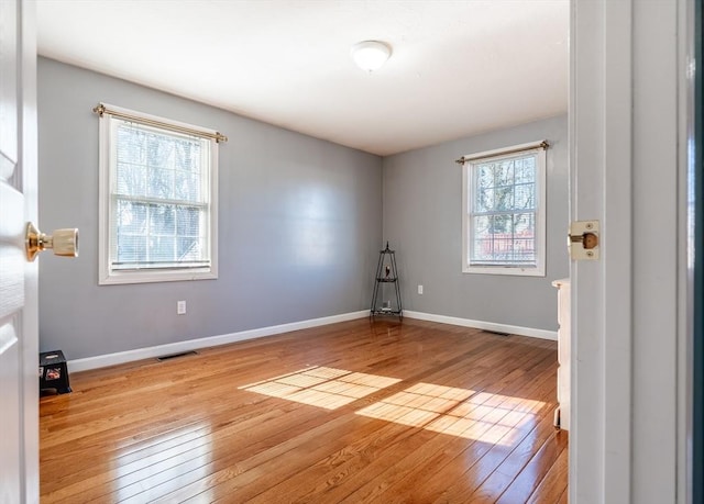 unfurnished room with light hardwood / wood-style flooring