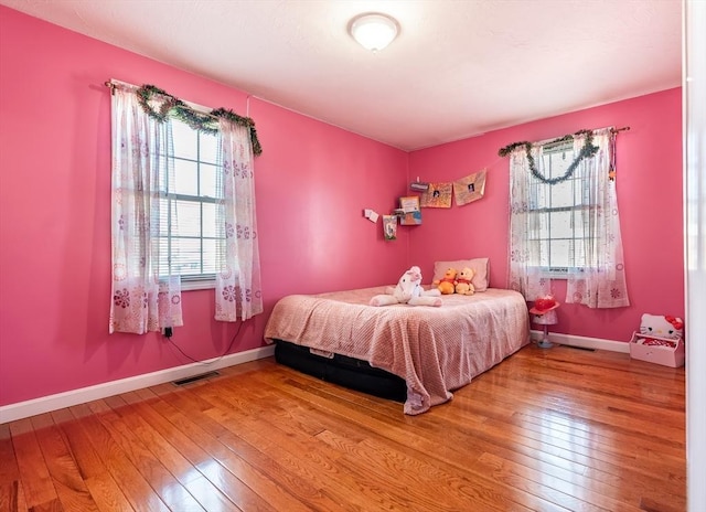 bedroom with hardwood / wood-style flooring