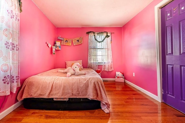 bedroom with wood-type flooring