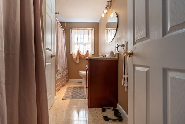 bathroom featuring curtained shower, tile patterned floors, toilet, and vanity