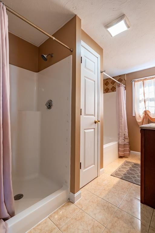 bathroom with tile patterned flooring, vanity, curtained shower, and a textured ceiling