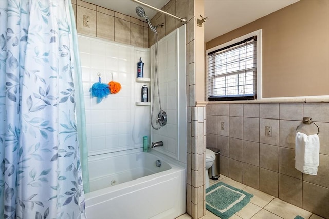 bathroom featuring tile walls, tile patterned flooring, toilet, and shower / bath combo with shower curtain