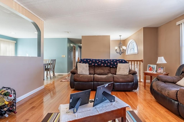 living room featuring a notable chandelier and light hardwood / wood-style floors