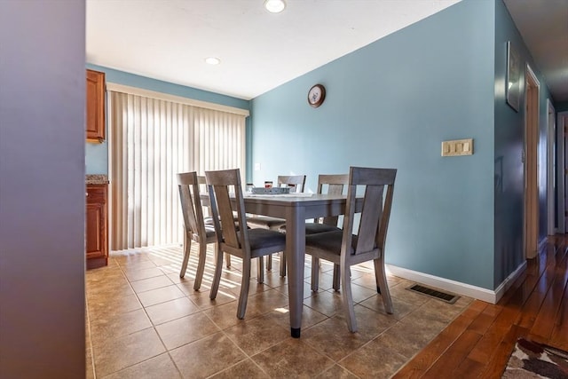 dining room with dark tile patterned floors