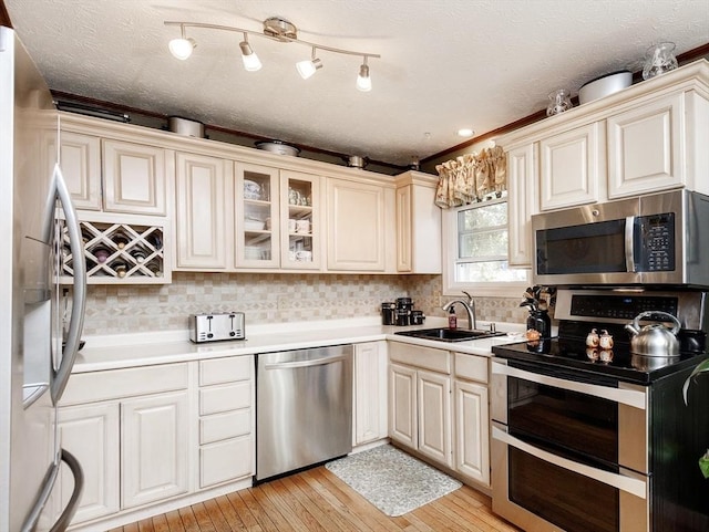 171 David Cir, Putnam, CT 06260 - kitchen featuring stainless steel appliances, light countertops, backsplash, and glass insert cabinets