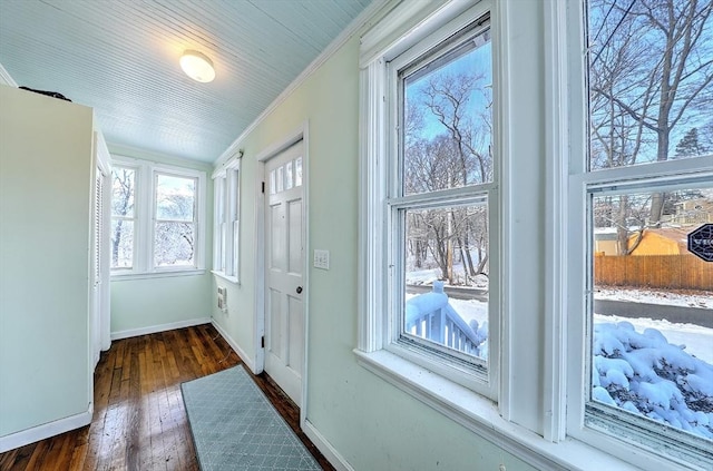 entryway featuring ornamental molding and dark hardwood / wood-style floors