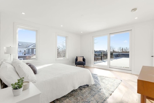 bedroom featuring light hardwood / wood-style flooring and access to outside