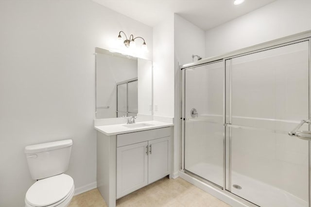 bathroom with vanity, toilet, and a shower with door