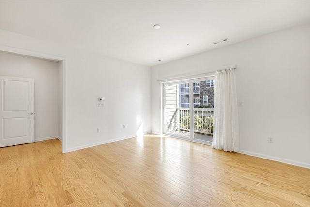 spare room with light wood-type flooring