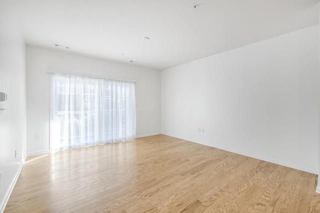 unfurnished room with light wood-type flooring