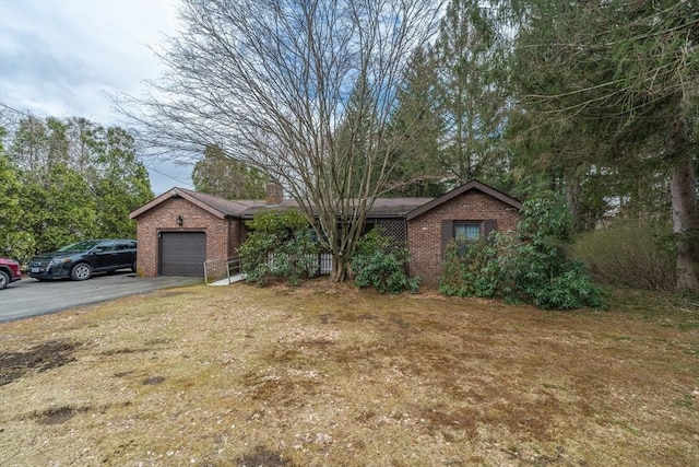 399 Elm St, East Longmeadow, MA 01028 - view of front of house with brick siding, asphalt driveway, an attached garage, and a front yard