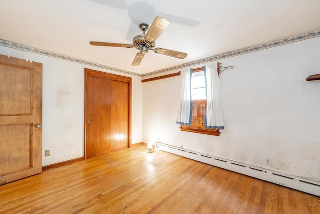 399 Elm St, East Longmeadow, MA 01028 - unfurnished bedroom featuring a baseboard heating unit, light wood-style floors, a closet, ceiling fan, and baseboards