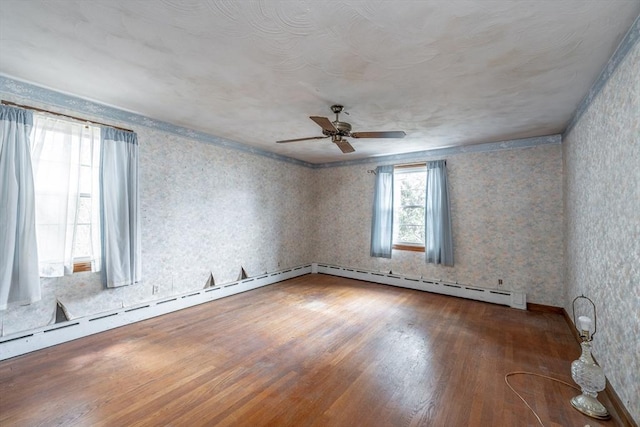 399 Elm St, East Longmeadow, MA 01028 - empty room with a ceiling fan, wood finished floors, baseboard heating, wallpapered walls, and baseboards