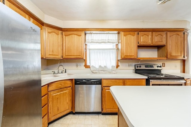 399 Elm St, East Longmeadow, MA 01028 - kitchen with stainless steel appliances, a sink, light countertops, and brown cabinets