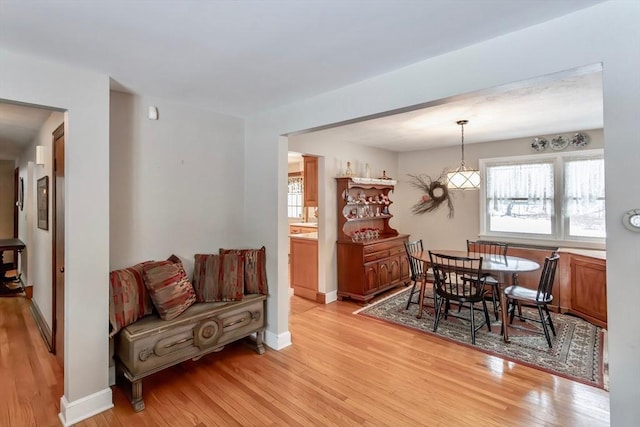 dining area featuring baseboards and light wood-style floors