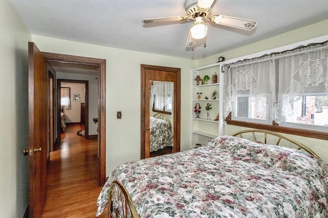 bedroom with a ceiling fan and wood finished floors