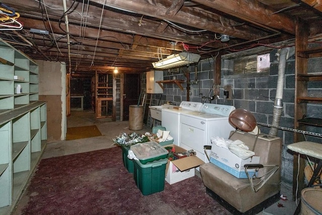 unfinished basement featuring washer and clothes dryer and a sink