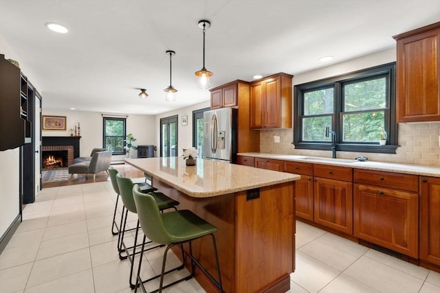 85 Green Meadow Ct, Northbridge, MA 01588 - kitchen with stainless steel refrigerator with ice dispenser, a sink, brown cabinetry, decorative backsplash, and recessed lighting