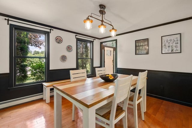 85 Green Meadow Ct, Northbridge, MA 01588 - dining space featuring a wainscoted wall, plenty of natural light, light wood-type flooring, crown molding, and a baseboard heating unit