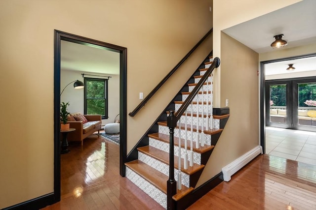 85 Green Meadow Ct, Northbridge, MA 01588 - staircase featuring baseboard heating, plenty of natural light, hardwood / wood-style flooring, and baseboards