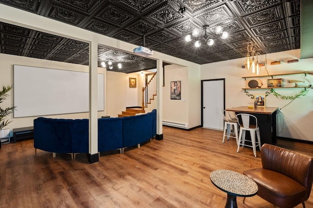 85 Green Meadow Ct, Northbridge, MA 01588 - living room featuring an ornate ceiling, a baseboard heating unit, a chandelier, wood finished floors, and stairs