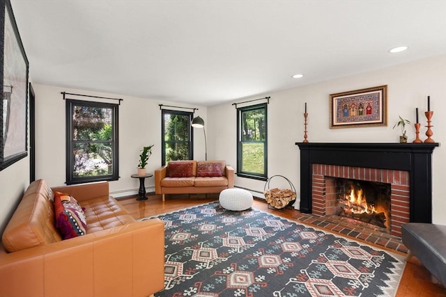 85 Green Meadow Ct, Northbridge, MA 01588 - living room featuring baseboard heating, a baseboard radiator, a fireplace, wood finished floors, and recessed lighting