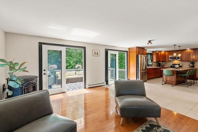 85 Green Meadow Ct, Northbridge, MA 01588 - living area with baseboard heating and light wood-style flooring