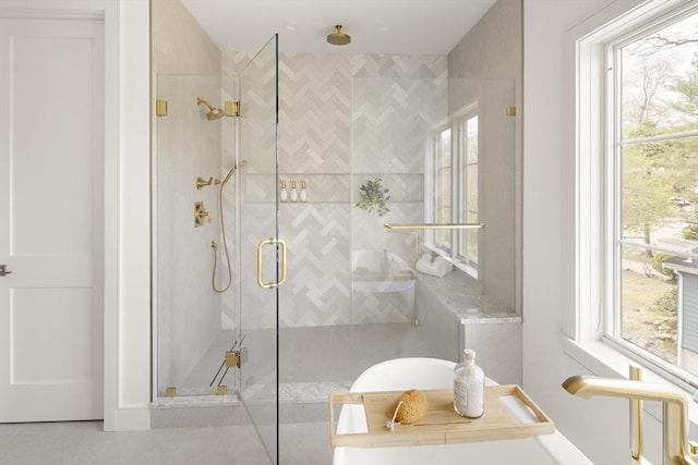 bathroom with a stall shower and healthy amount of natural light