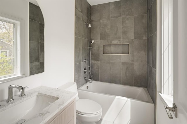 full bath featuring healthy amount of natural light, toilet, shower / bathtub combination, and vanity