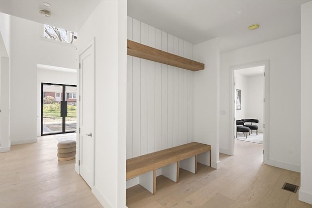 mudroom featuring light wood-style flooring and baseboards