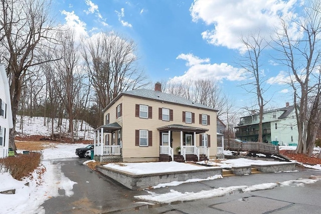 view of front of property with cooling unit and a porch