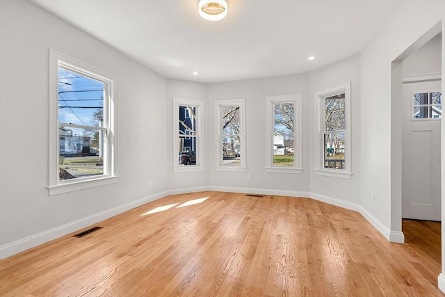 13 River St Unit 1, Danvers, MA 01923 - spare room with light wood-type flooring, visible vents, baseboards, and a healthy amount of sunlight