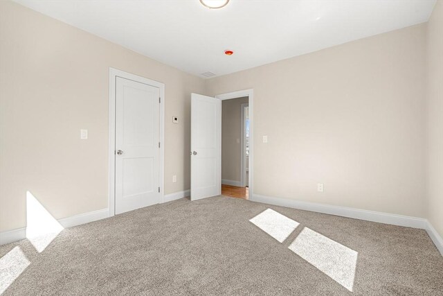 13 River St Unit 1, Danvers, MA 01923 - unfurnished bedroom featuring baseboards and light colored carpet