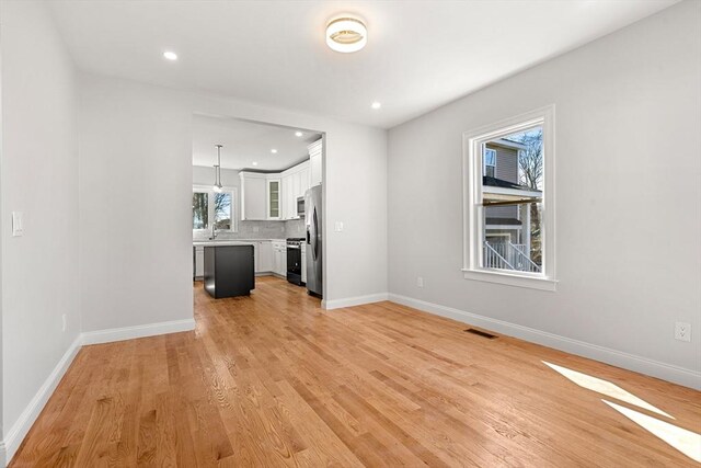 13 River St Unit 1, Danvers, MA 01923 - unfurnished living room featuring recessed lighting, baseboards, visible vents, and light wood-style flooring