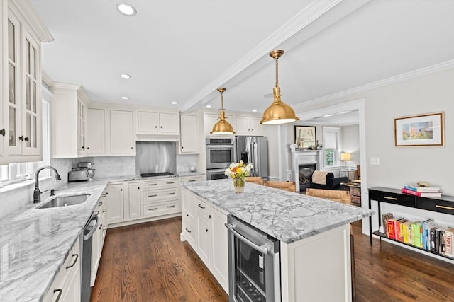 161 Hollett St, Scituate, MA 02066 - kitchen with stainless steel appliances, recessed lighting, wine cooler, white cabinetry, and a fireplace