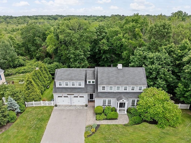 161 Hollett St, Scituate, MA 02066 - view of front of property featuring driveway, a view of trees, a garage, and a shingled roof