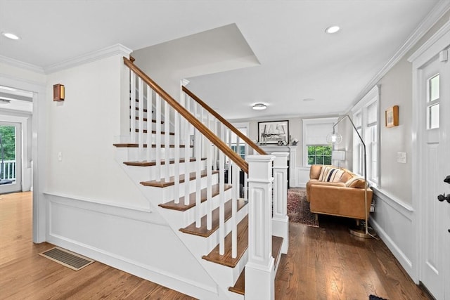 161 Hollett St, Scituate, MA 02066 - stairway featuring healthy amount of natural light, wood finished floors, crown molding, a decorative wall, and recessed lighting