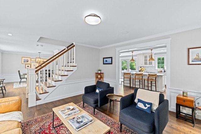 161 Hollett St, Scituate, MA 02066 - living area with stairway, crown molding, wood finished floors, a chandelier, and a wainscoted wall