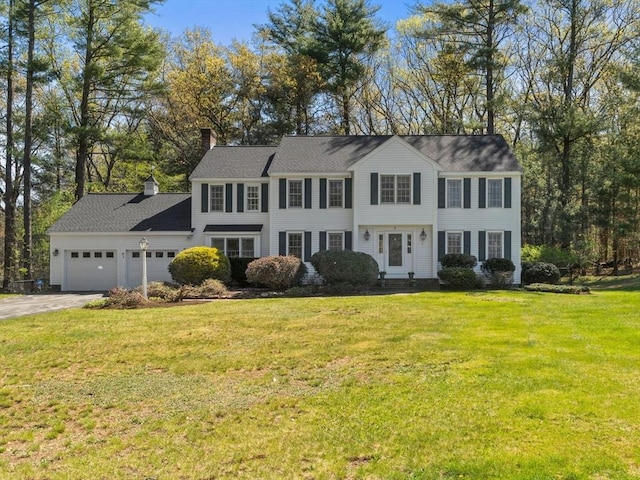 8 Kennedy Ln, Acton, MA 01720 - colonial house featuring an attached garage, driveway, a chimney, and a front lawn